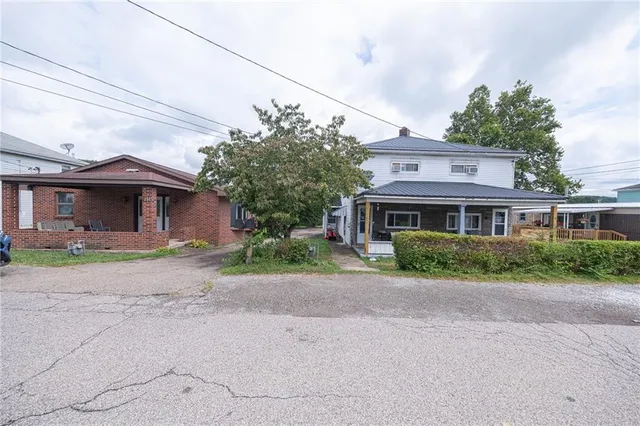 a front view of a house with a yard and a garage