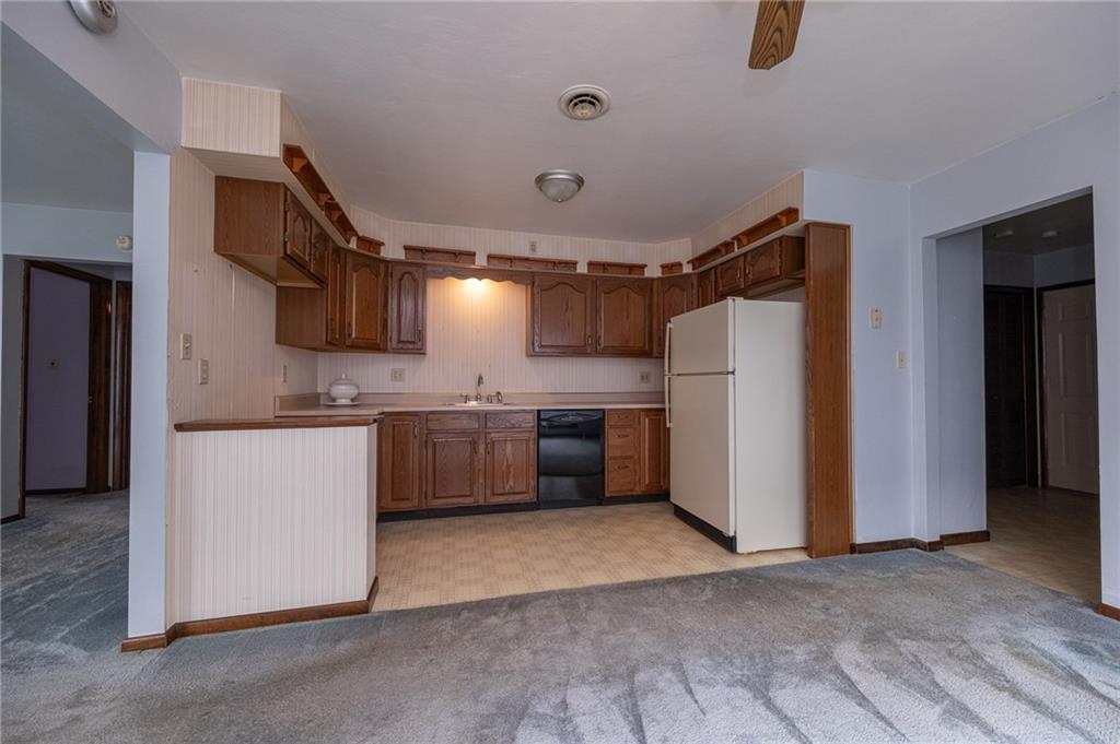 221-227 Spring Street Harwick, PA 15049 - Photo 11 of 49 a kitchen with a refrigerator sink and white cabinets