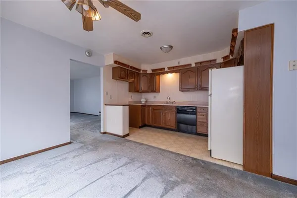 a kitchen with stainless steel appliances a refrigerator and a microwave