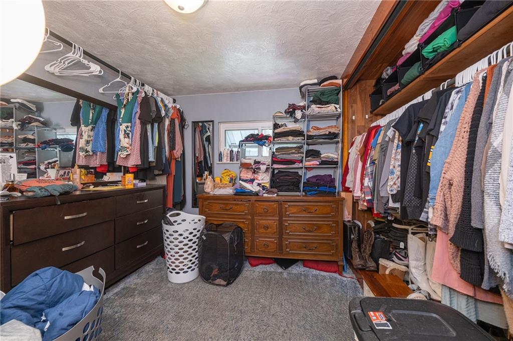 221-227 Spring Street Harwick, PA 15049 - Photo 31 of 49 a view of walk in closet with clothes and shoes