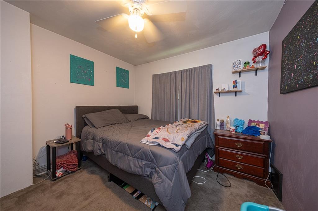 221-227 Spring Street Harwick, PA 15049 - Photo 40 of 49 a bedroom with a bed and a chandelier