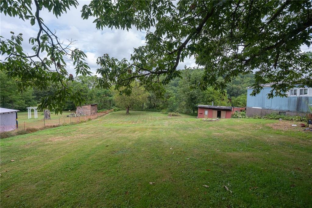 221-227 Spring Street Harwick, PA 15049 - Photo 43 of 49 a view of a big yard with plants and trees