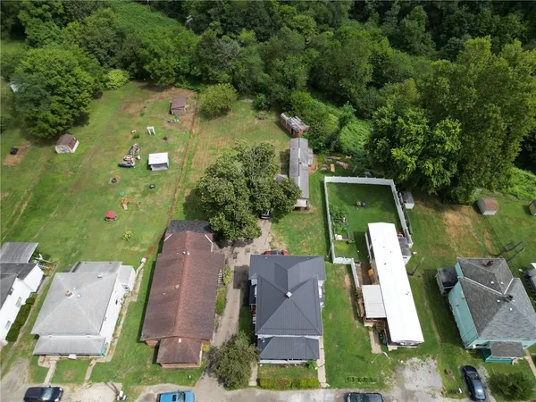 an aerial view of a house with garden space and street view