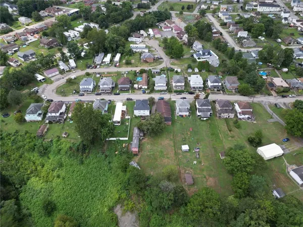 an aerial view of houses with yard