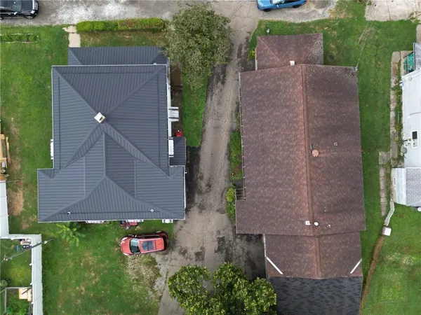 an aerial view of a house with a yard