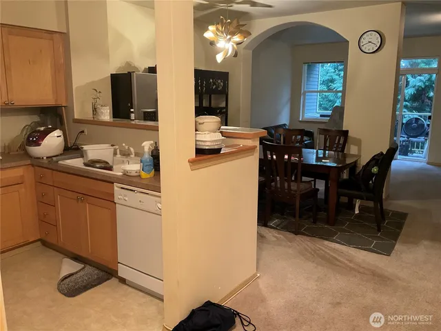 a kitchen with cabinets and chairs