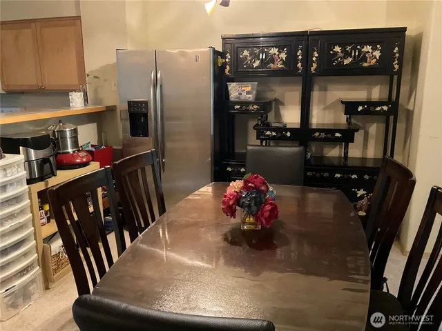 a kitchen with a table and chairs