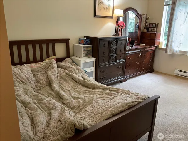 a bed sitting in a bedroom next to a window