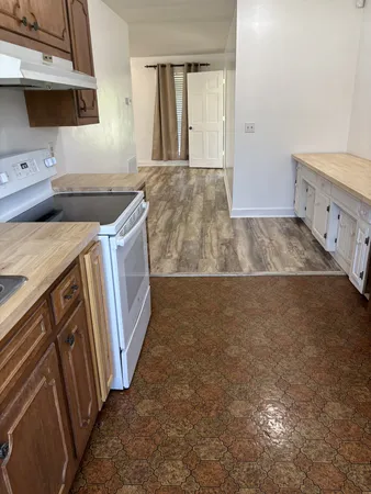 a kitchen with stainless steel appliances a refrigerator and a counter top