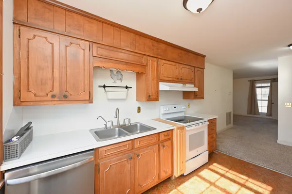 a kitchen with a sink cabinets and wooden floor