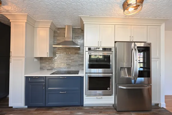 a kitchen with granite countertop a sink and cabinets