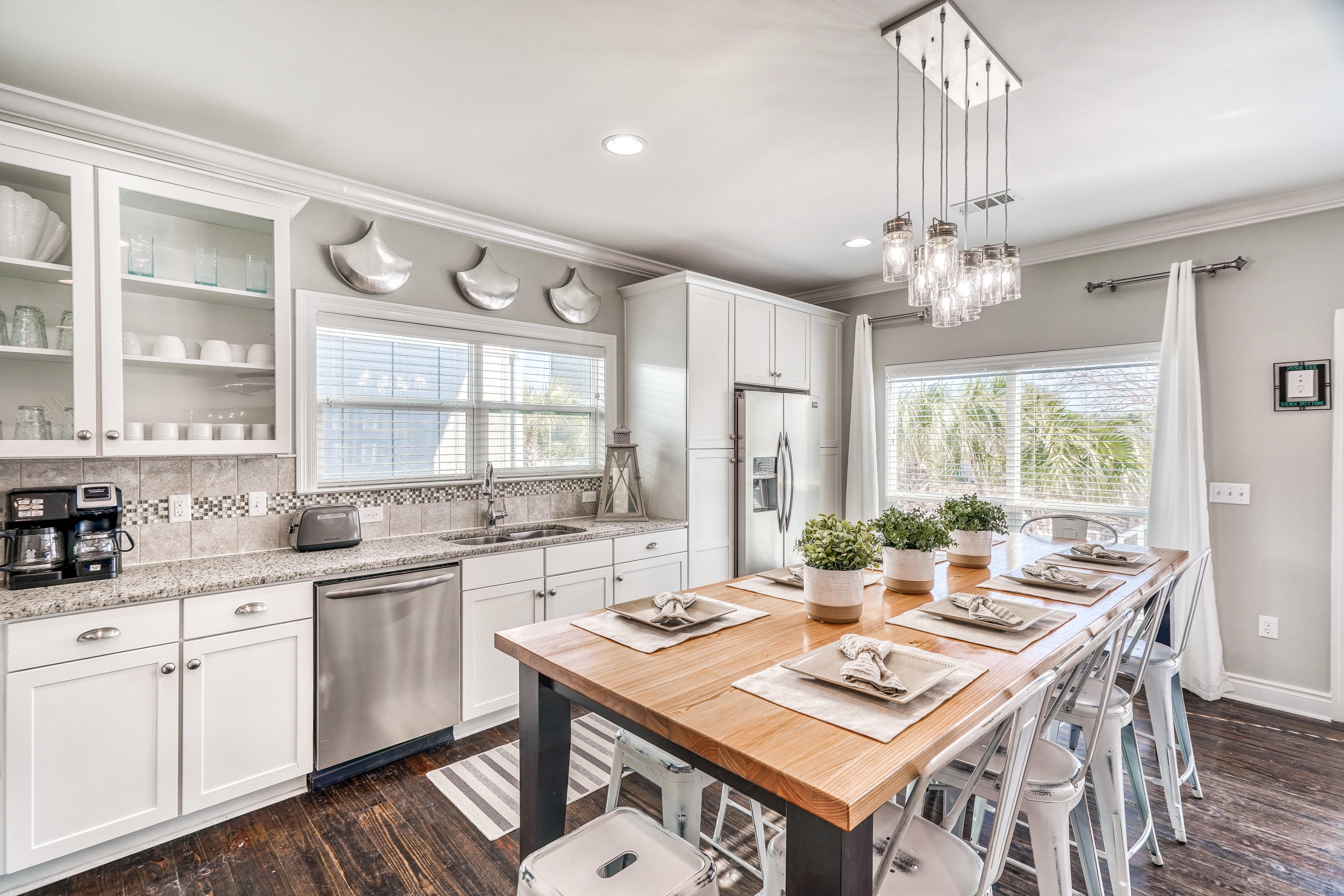29 Payne Street Miramar Beach, FL 32550 - Photo 13 of 49 a dining room with wooden floor a chandelier a wooden table and chairs