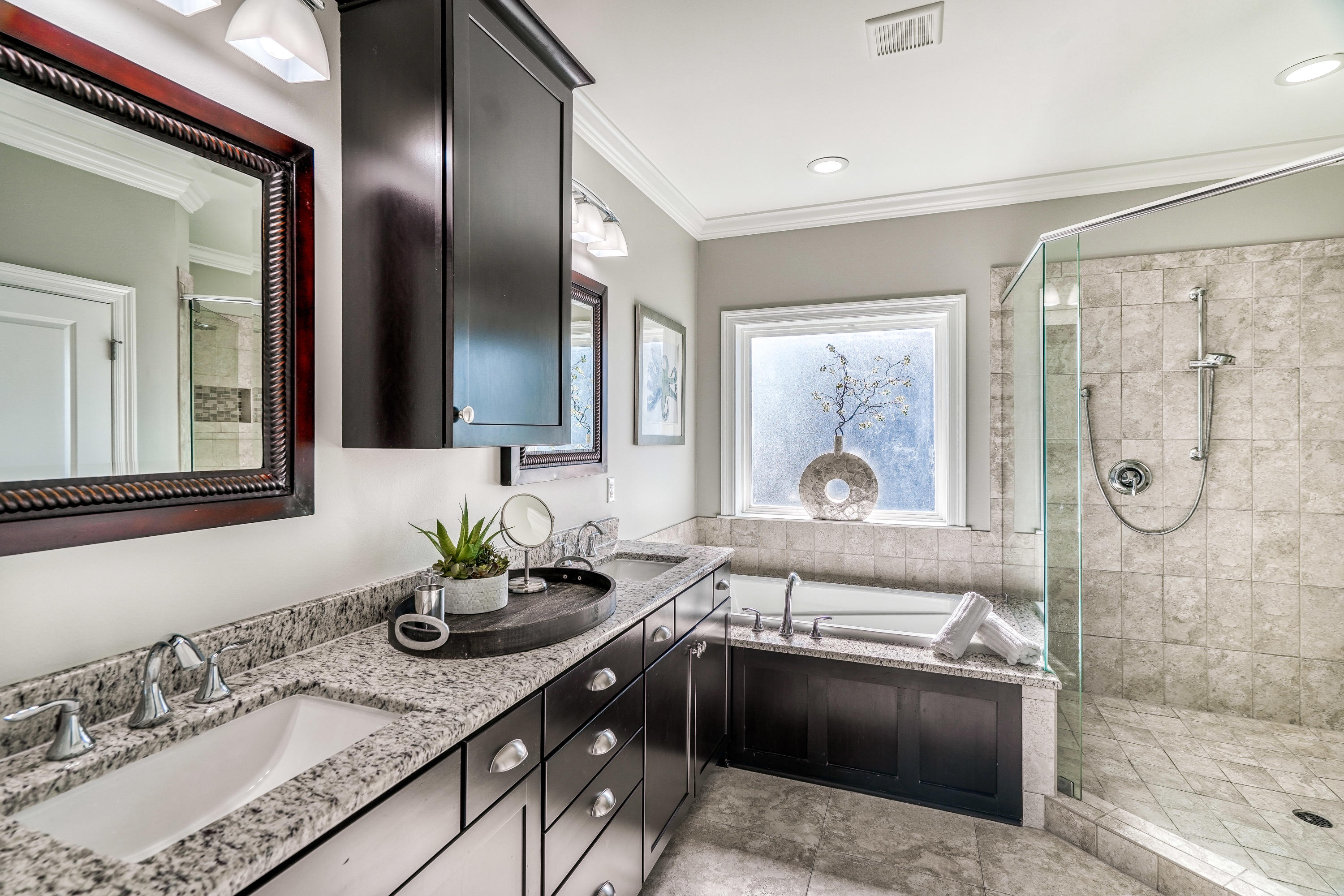 29 Payne Street Miramar Beach, FL 32550 - Photo 20 of 49 a bathroom with a granite countertop bathtub sink vanity and mirror