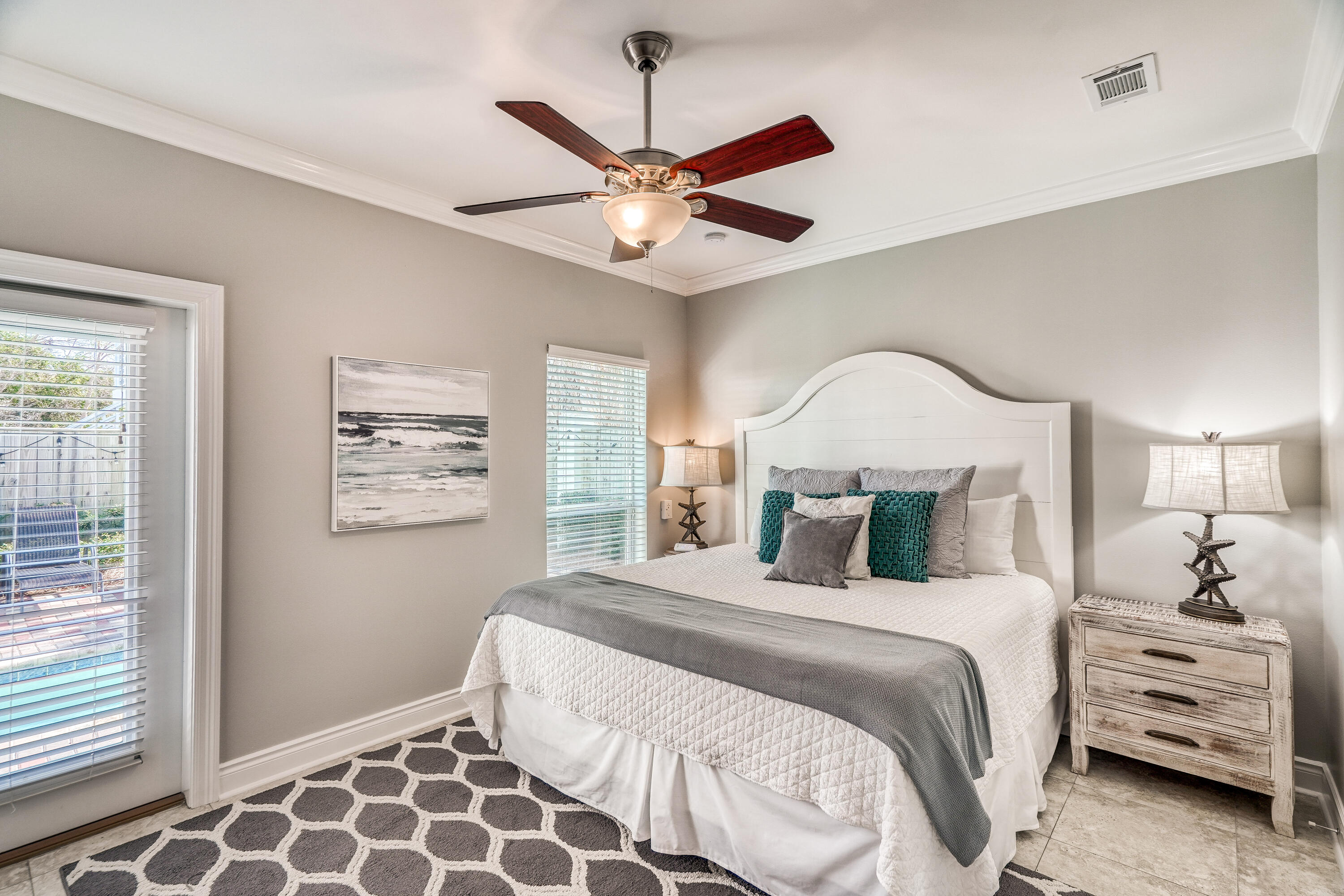 29 Payne Street Miramar Beach, FL 32550 - Photo 31 of 49 a bedroom with a large bed and a chandelier