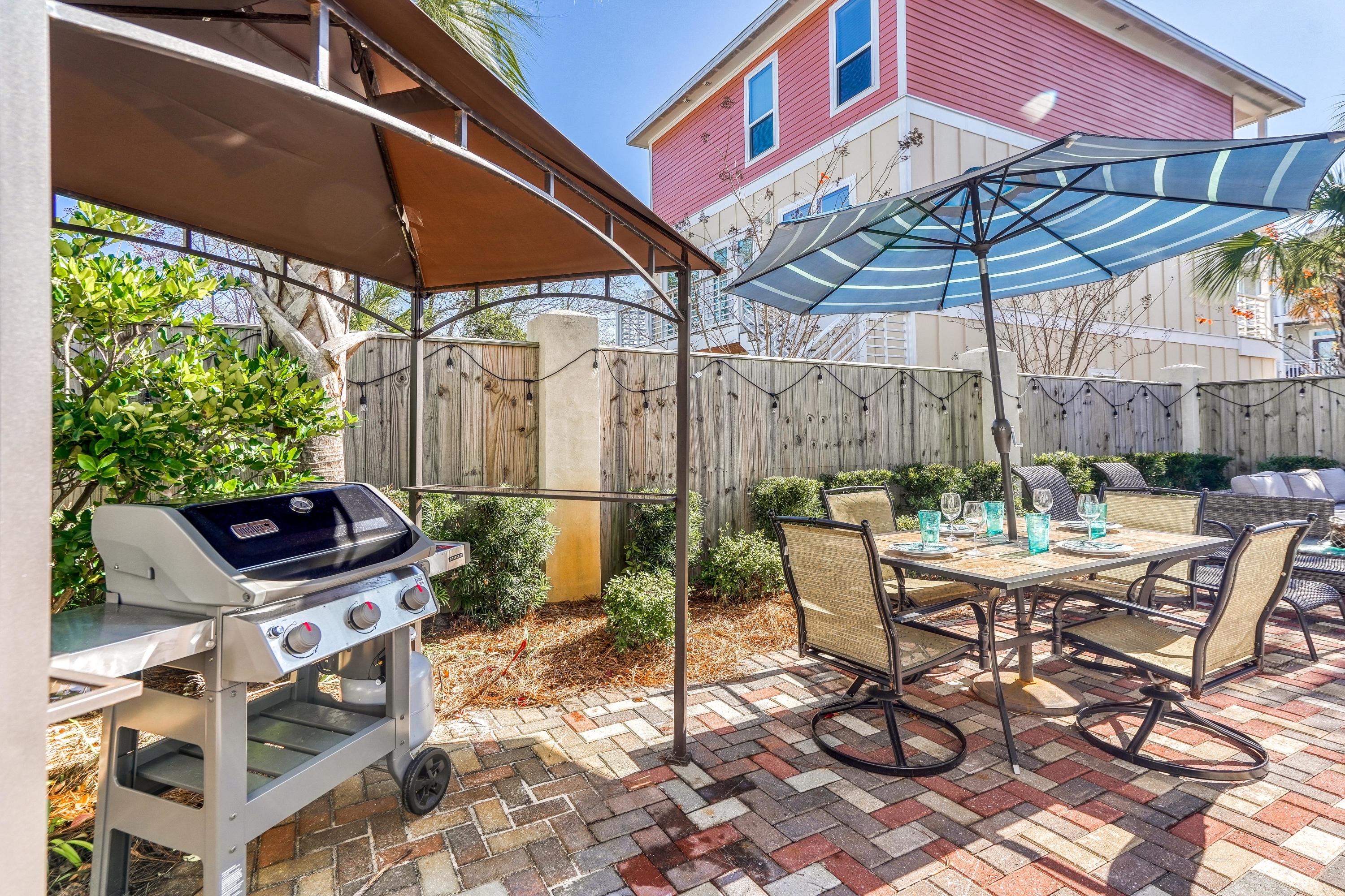 29 Payne Street Miramar Beach, FL 32550 - Photo 41 of 49 a view of a patio with a table and chairs under an umbrella