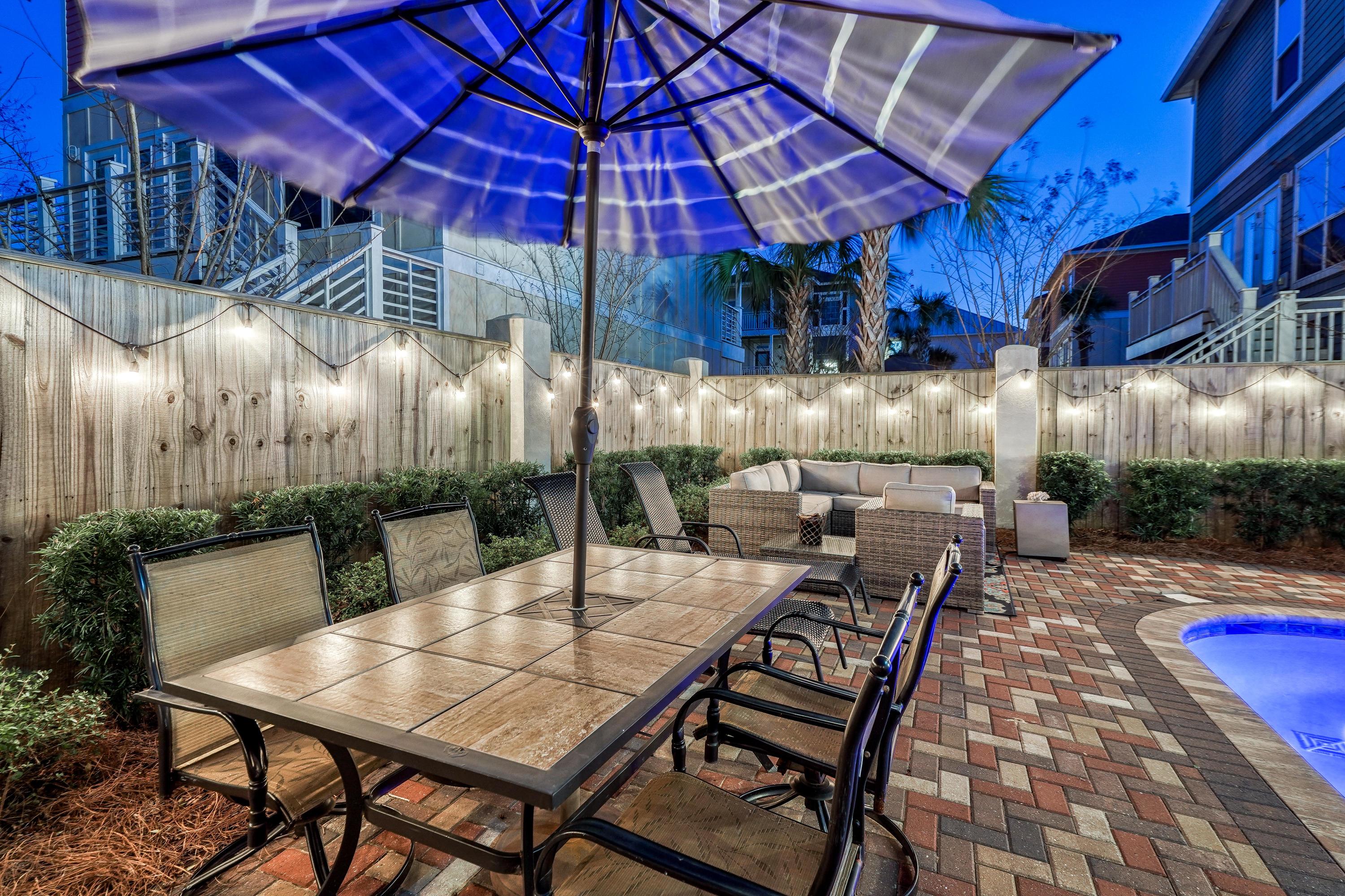29 Payne Street Miramar Beach, FL 32550 - Photo 46 of 49 a view of a patio with table and chairs under an umbrella
