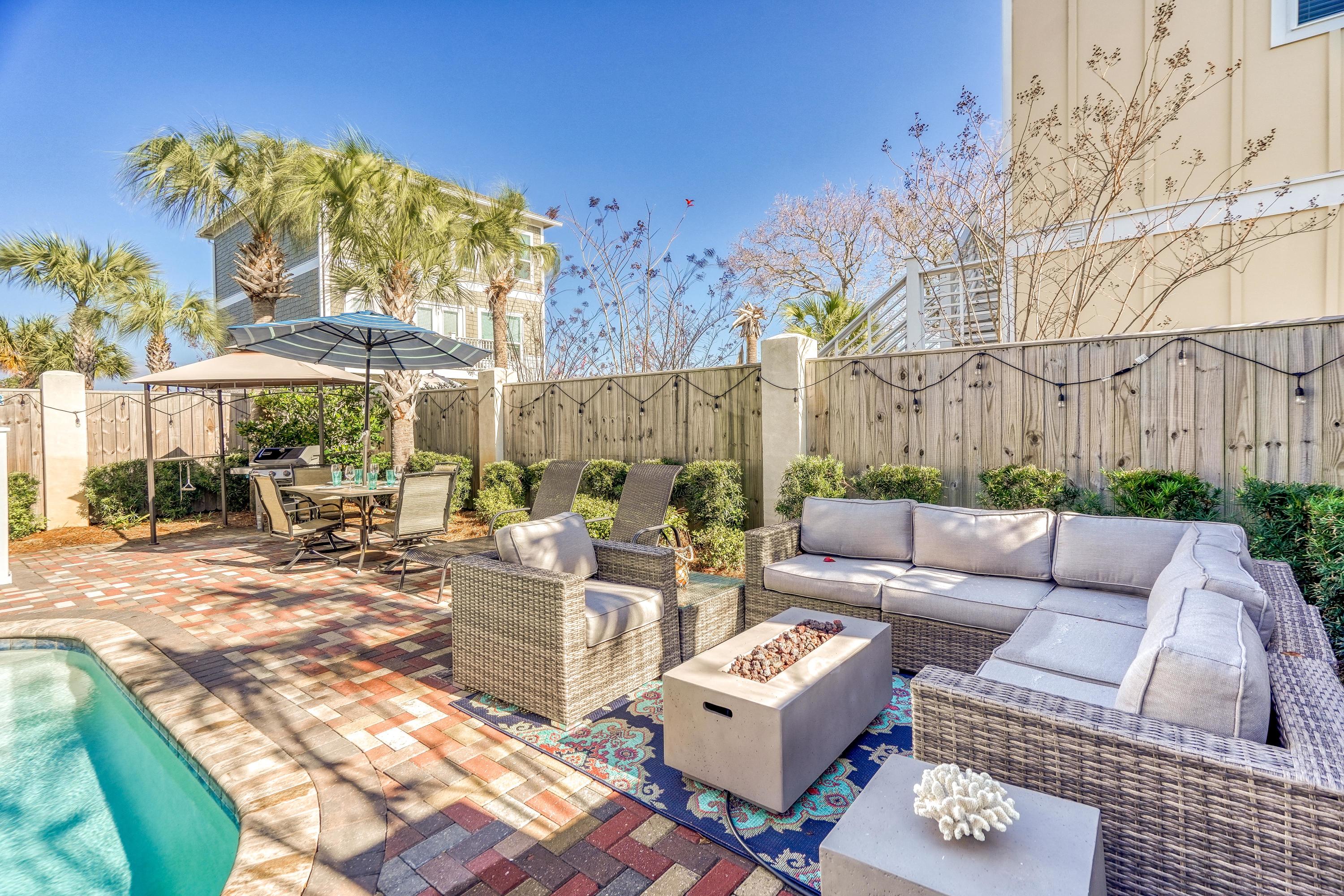 29 Payne Street Miramar Beach, FL 32550 - Photo 7 of 49 a view of a patio with couches table and chairs with wooden fence