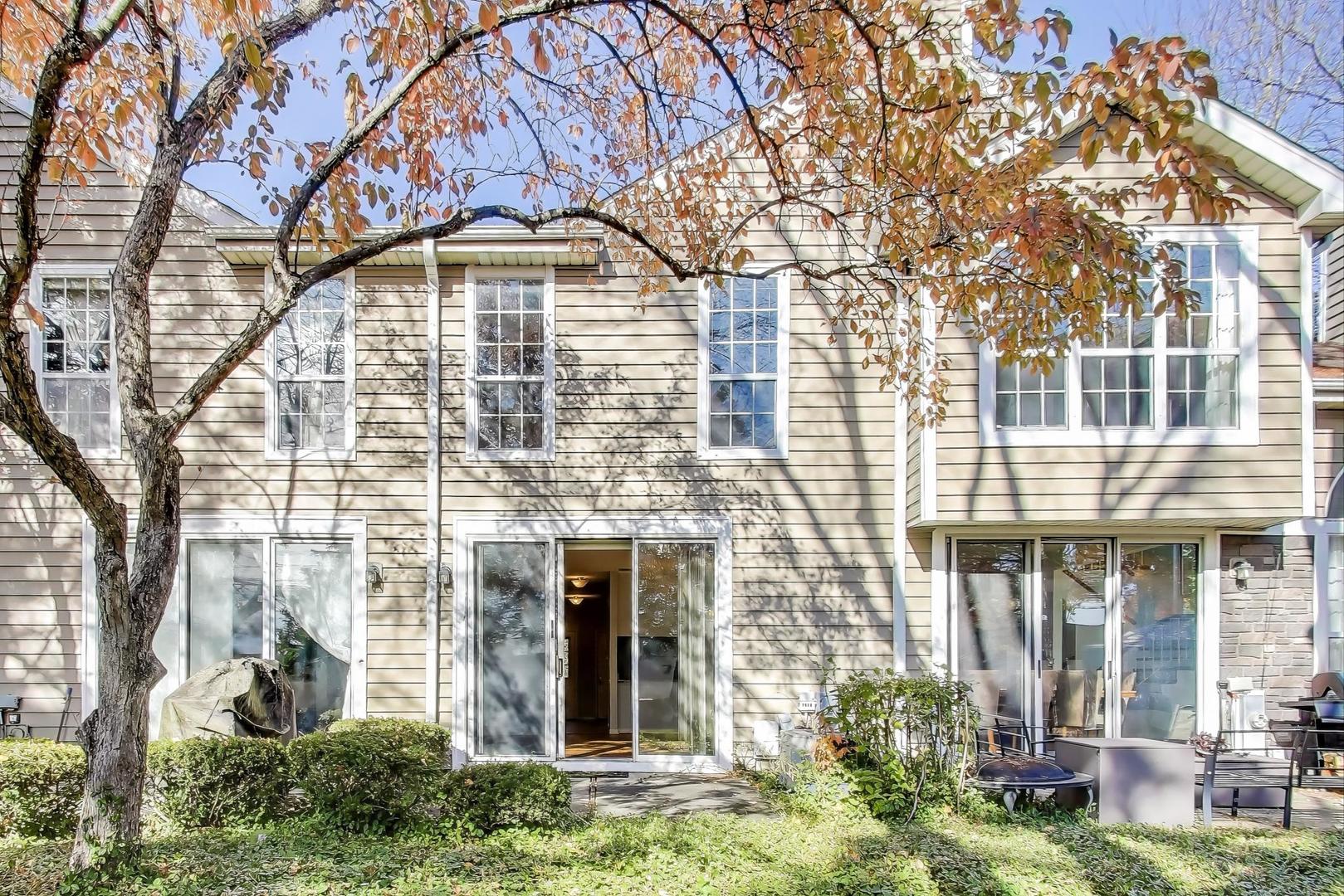 1303 Cranbrook Court Schaumburg, IL 60193 - Photo 19 of 29 front view of a brick house with a yard