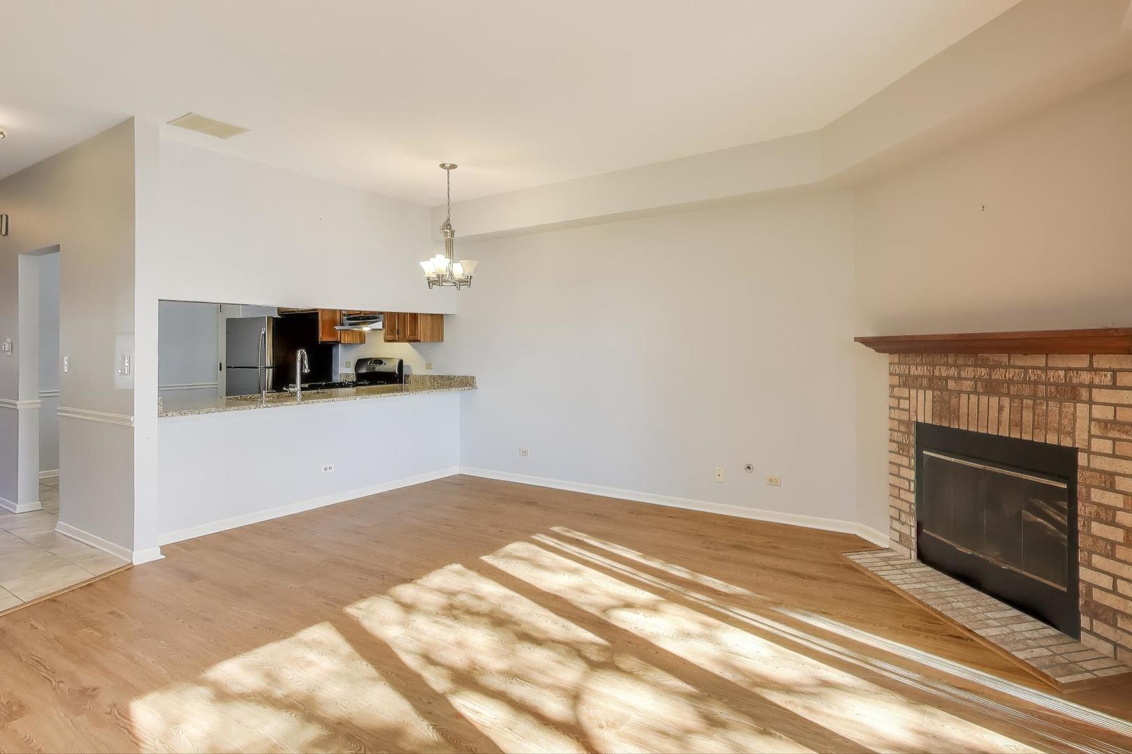 1303 Cranbrook Court Schaumburg, IL 60193 - Photo 3 of 29 a view of a kitchen with microwave and cabinets