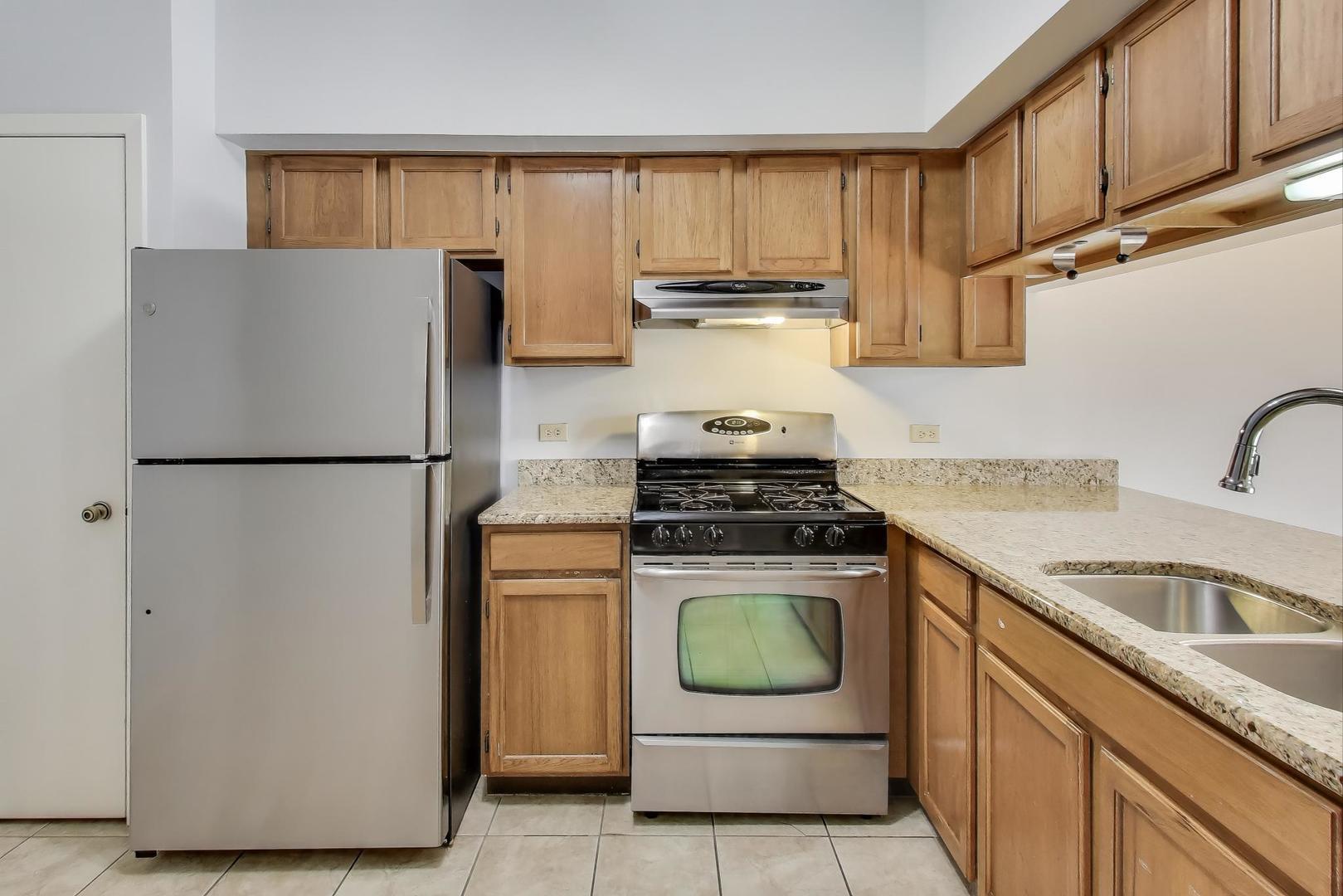 1303 Cranbrook Court Schaumburg, IL 60193 - Photo 6 of 29 a kitchen with stainless steel appliances granite countertop a refrigerator a stove a sink and dishwasher