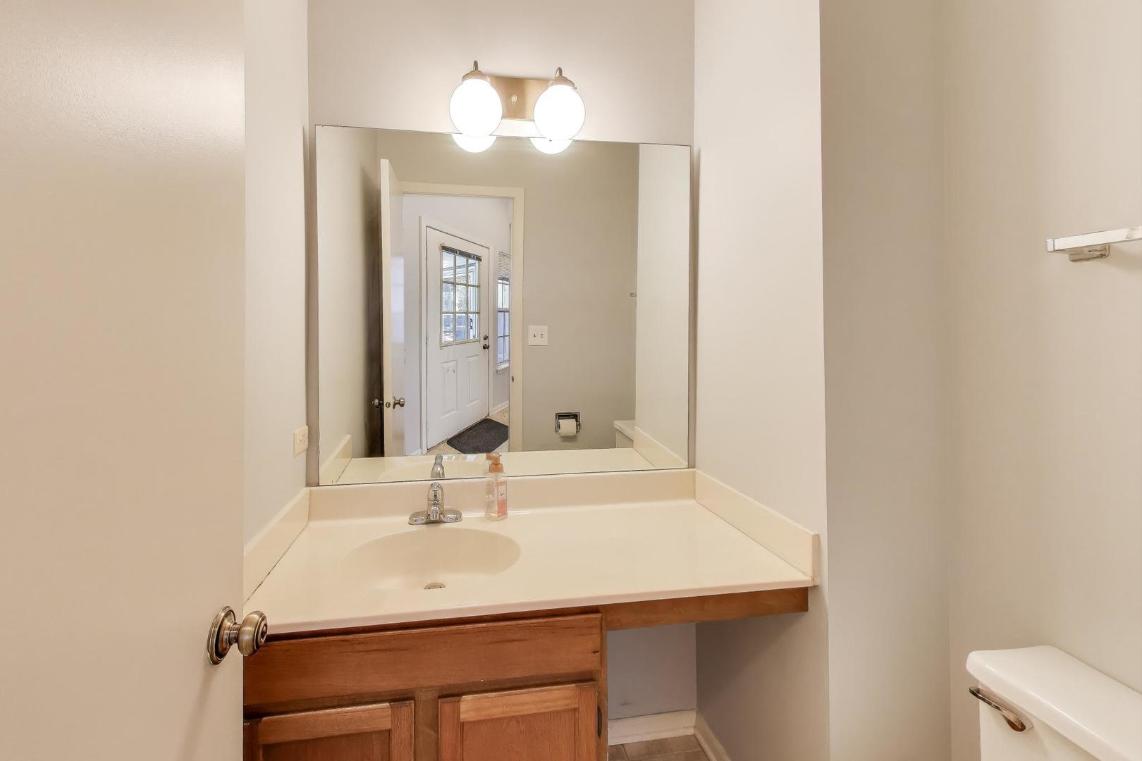 1303 Cranbrook Court Schaumburg, IL 60193 - Photo 7 of 29 a bathroom with a sink and a mirror