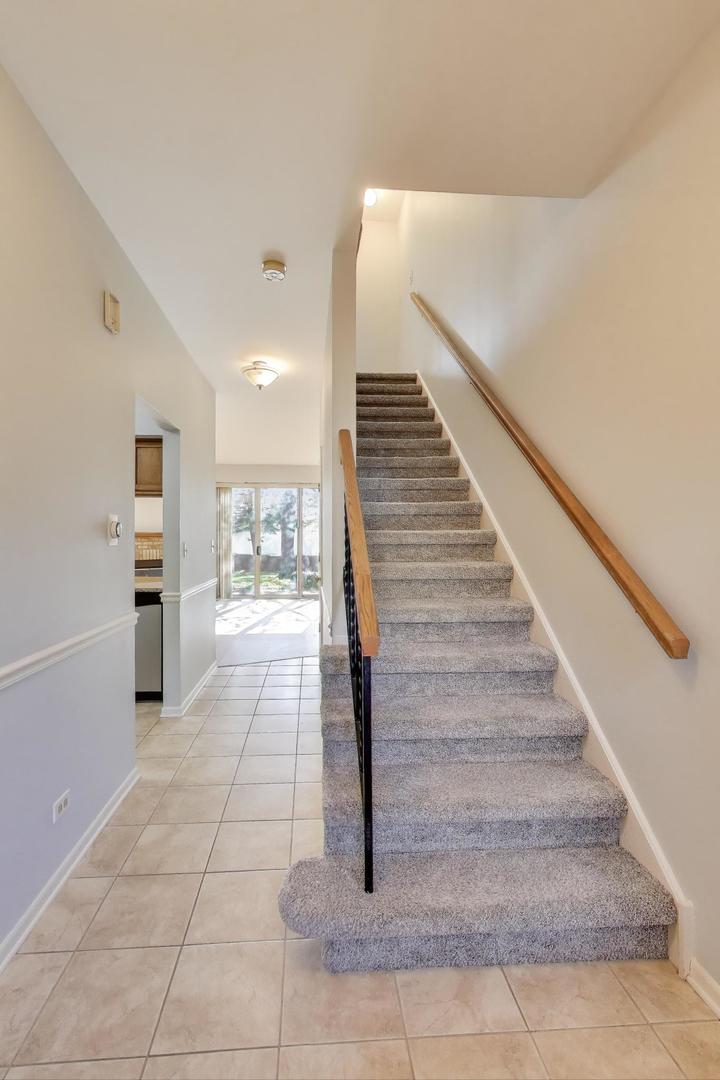 1303 Cranbrook Court Schaumburg, IL 60193 - Photo 8 of 29 a view of entryway and hall with a rug
