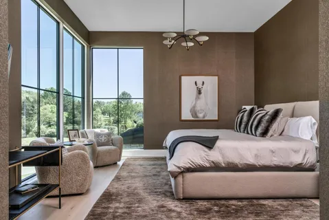 a bedroom with furniture and a large window