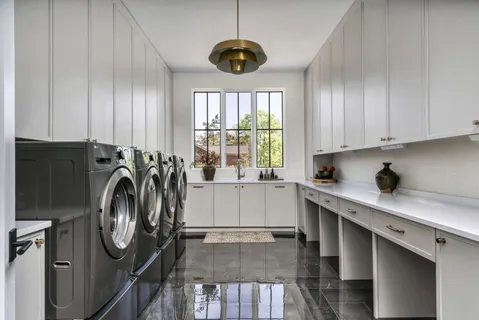a utility room with cabinets dryer and washer