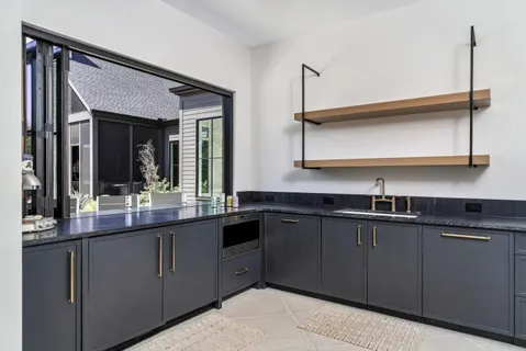a kitchen with stainless steel appliances granite countertop a sink and cabinets