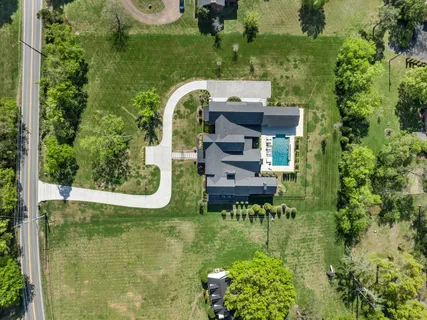 a view of a swimming pool with a yard