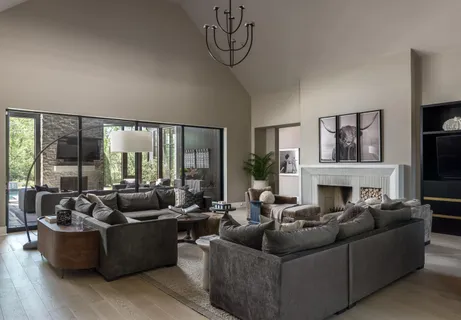 a living room with fireplace furniture and a large window