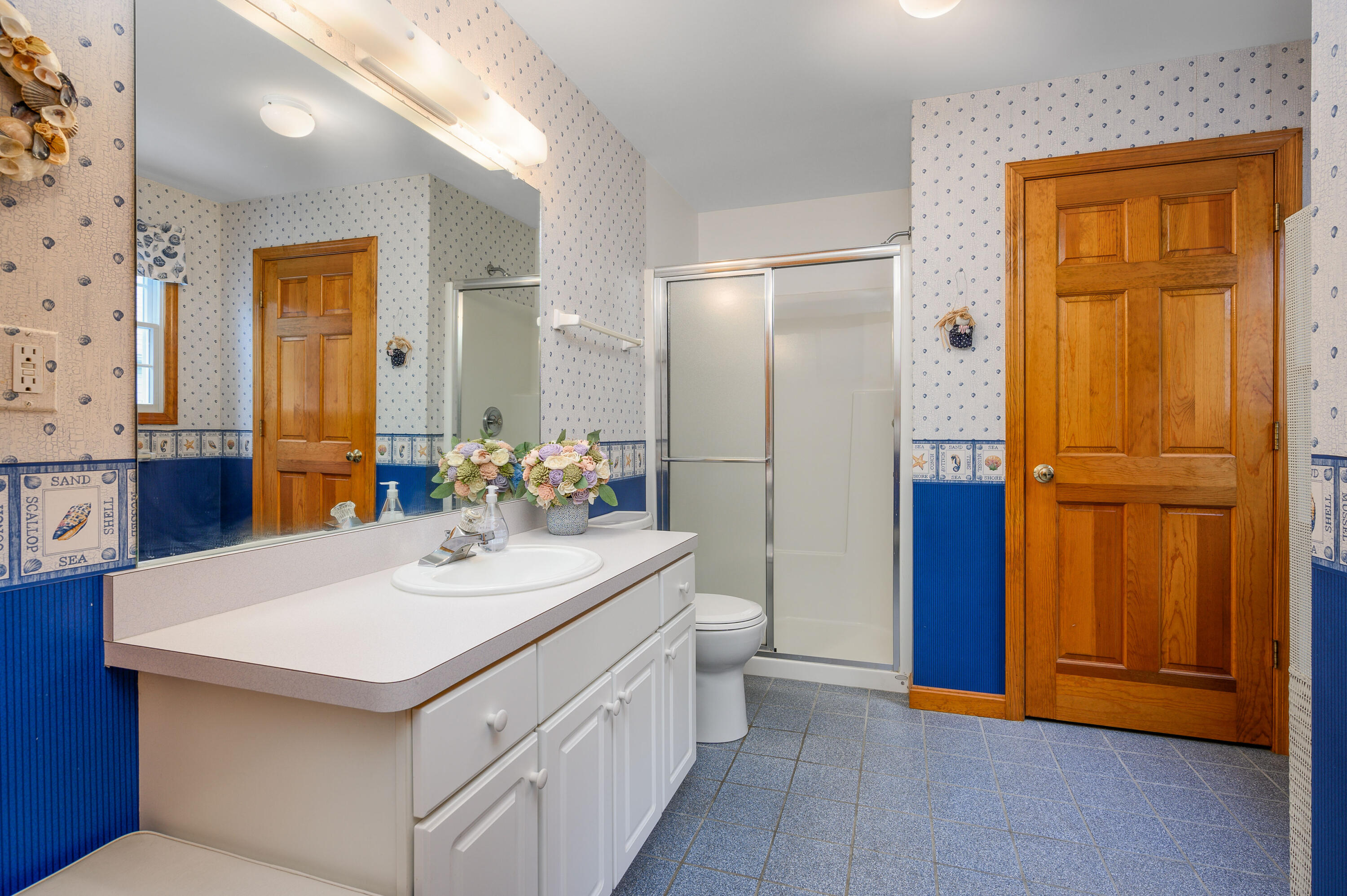 86 Old Wharf Road Wellfleet, MA 02667 - Photo 20 of 37 a bathroom with a sink a mirror and a shower