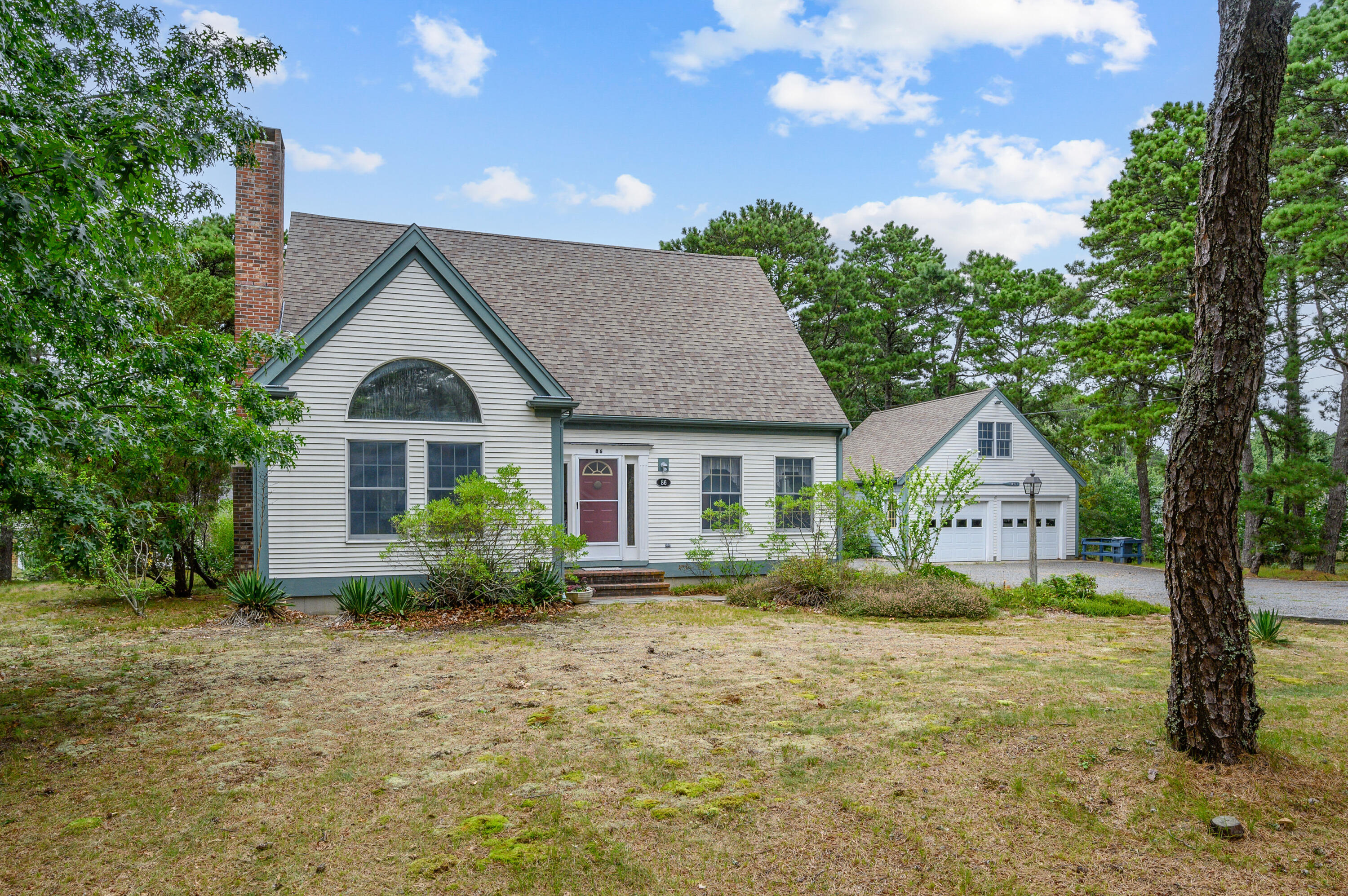 86 Old Wharf Road Wellfleet, MA 02667 - Photo 3 of 37 a front view of a house with garden