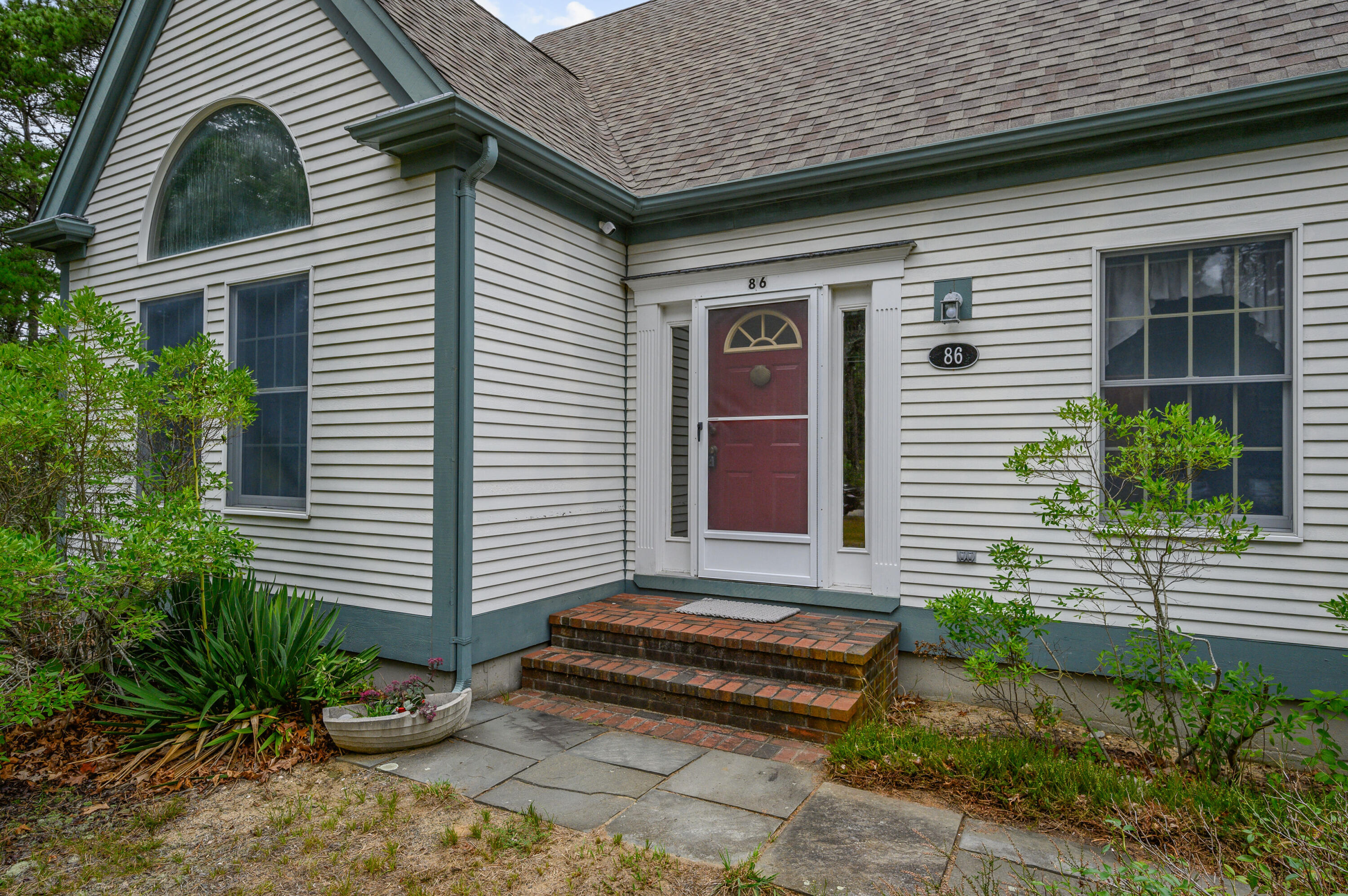 86 Old Wharf Road Wellfleet, MA 02667 - Photo 4 of 37 a front view of a house with a yard