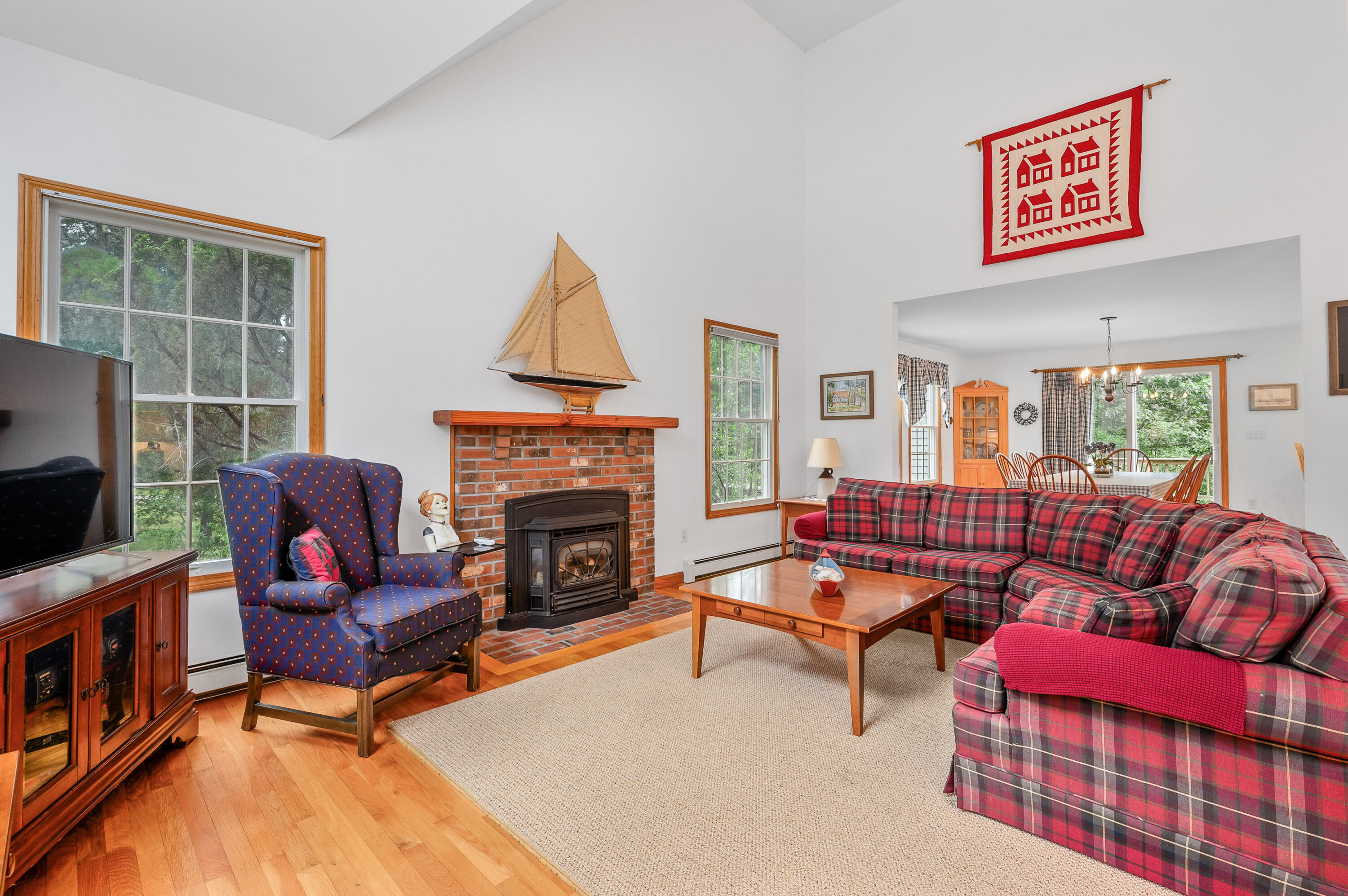 86 Old Wharf Road Wellfleet, MA 02667 - Photo 5 of 37 a living room with furniture a flat screen tv and a fireplace