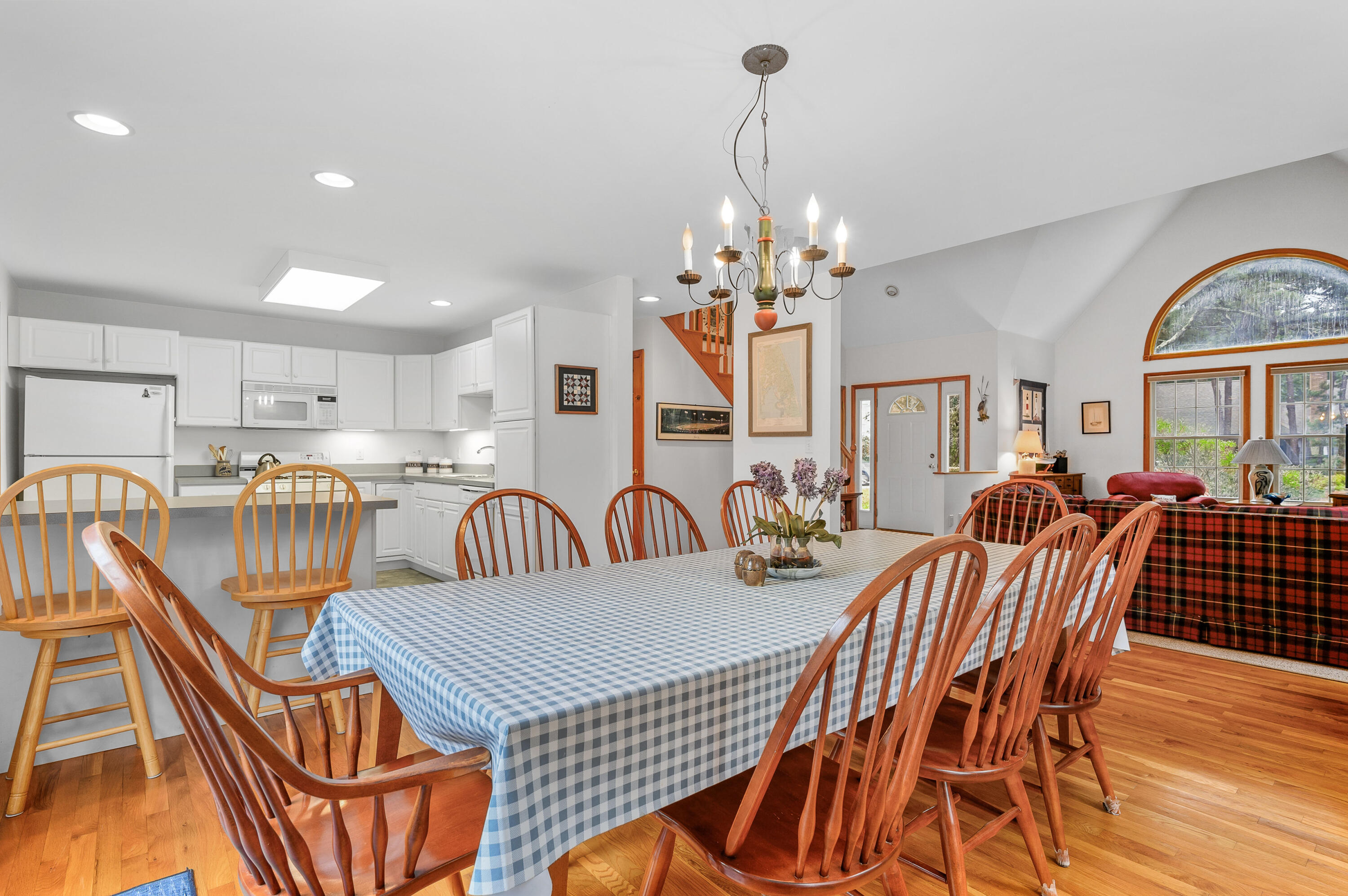 86 Old Wharf Road Wellfleet, MA 02667 - Photo 8 of 37 a view of a dining room with furniture a chandelier and wooden floor