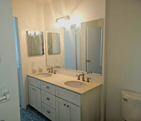 a bathroom with a double vanity sink and mirror