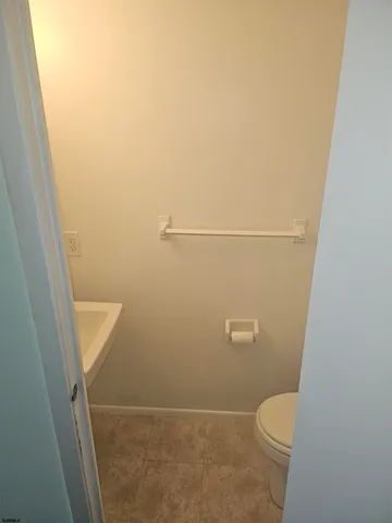 a bathroom with a white toilet and sink