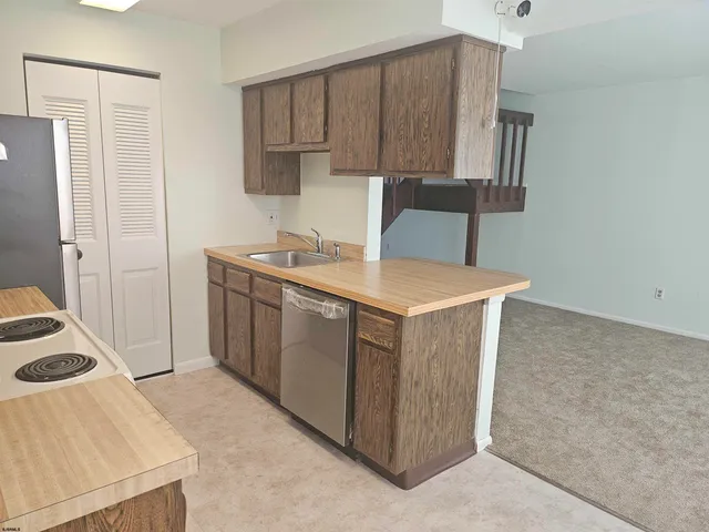 a utility room with sink dryer and washer