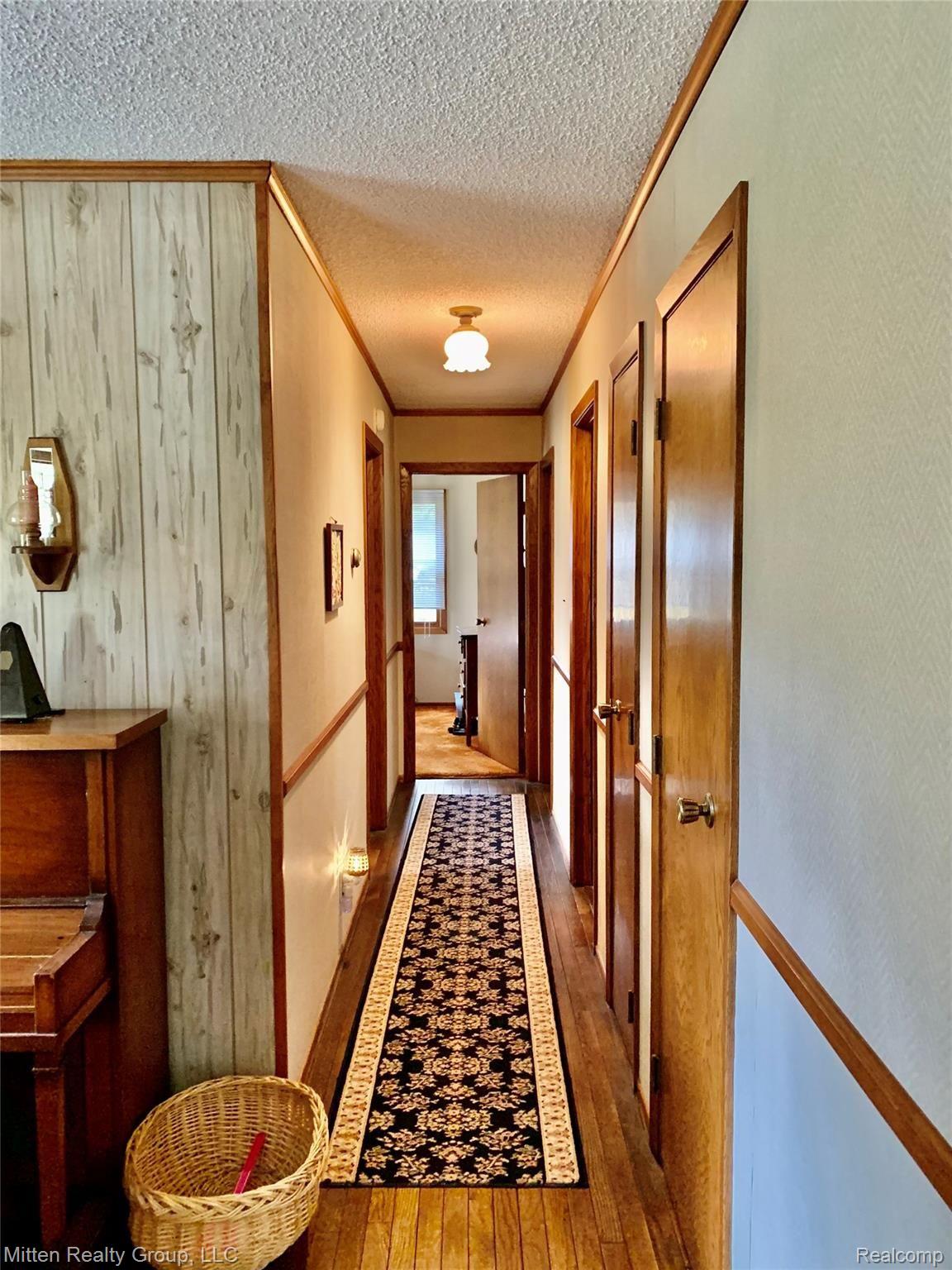 Hallway to bedrooms | 1 Bedroom on left | 1 Bedroom straight ahead | Hallway turns right at end to largest bedroom