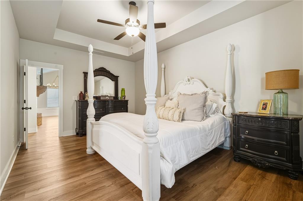 3462 Vinson Mountain Road Rockmart, GA 30153 - Photo 16 of 31 a large bedroom with a bed and wooden floor