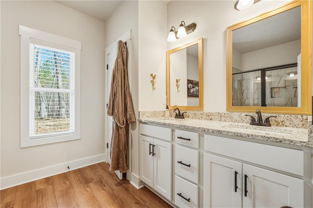 3462 Vinson Mountain Road Rockmart, GA 30153 - Photo 17 of 31 a bathroom with a granite countertop sink vanity mirror next to a window