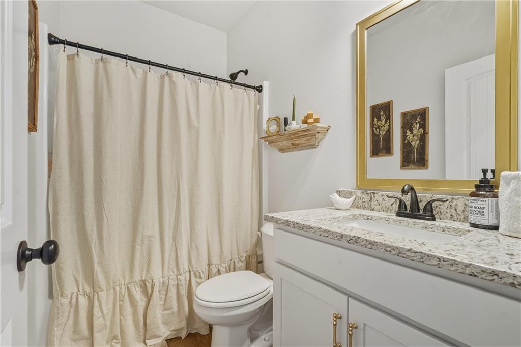 3462 Vinson Mountain Road Rockmart, GA 30153 - Photo 20 of 31 a bathroom with a granite countertop sink and a mirror