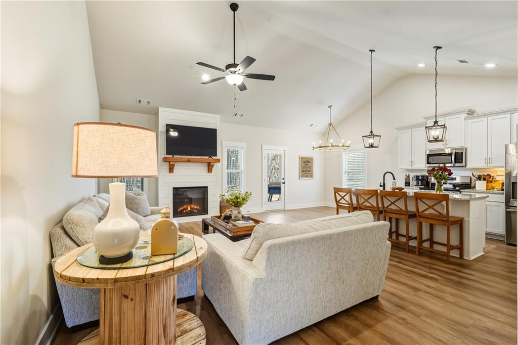 3462 Vinson Mountain Road Rockmart, GA 30153 - Photo 6 of 31 a living room with furniture a fireplace and a flat screen tv