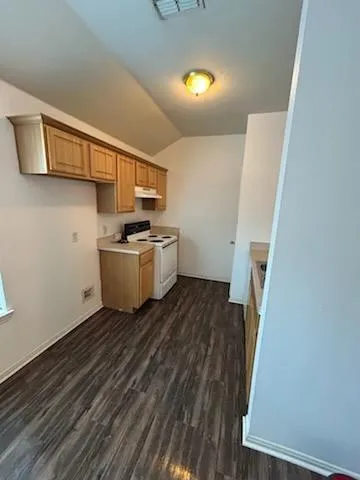 a room with a wooden floor and furniture