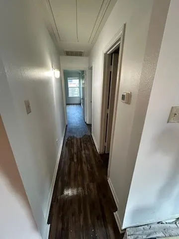 a view of hallway with wooden floor