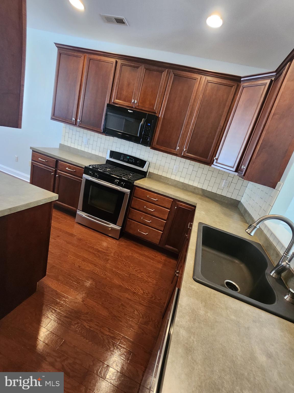 161 Stoyer Road Coatesville, PA 19320 - Photo 6 of 17 a kitchen with a stove and a microwave