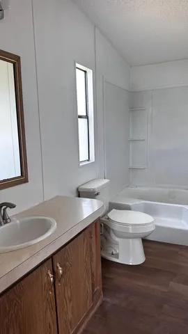 a bathroom with a sink toilet and mirror