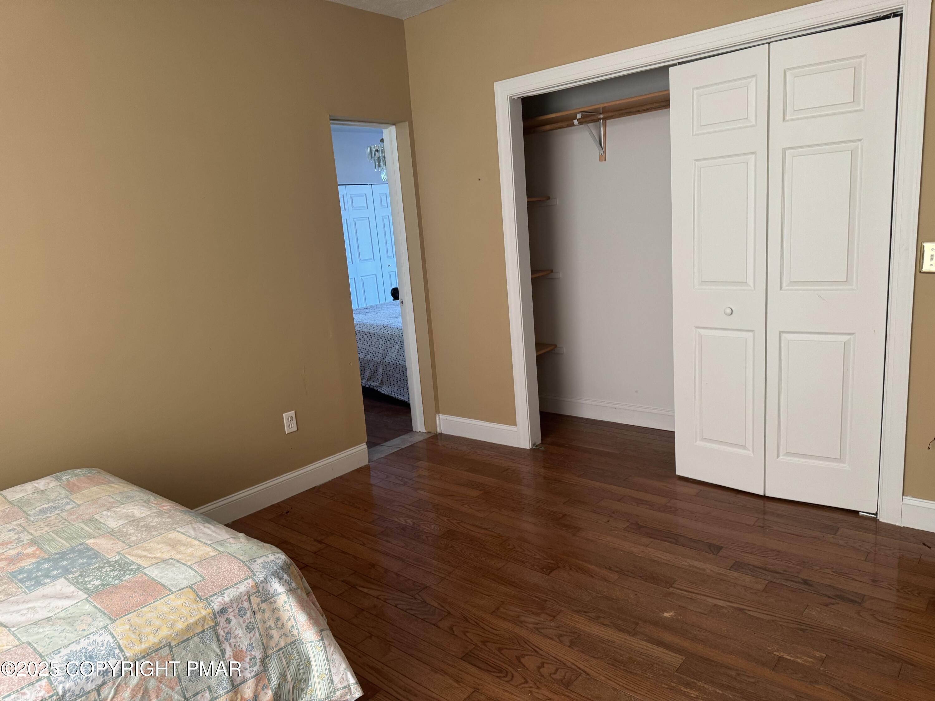 369 Bossardsville Road Stroudsburg, PA 18360 - Photo 13 of 17 a view of a room with wooden floor and closet area