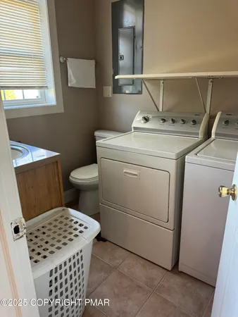 a bathroom with a toilet a sink and a mirror